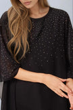 Top in mesh nero con decorazioni