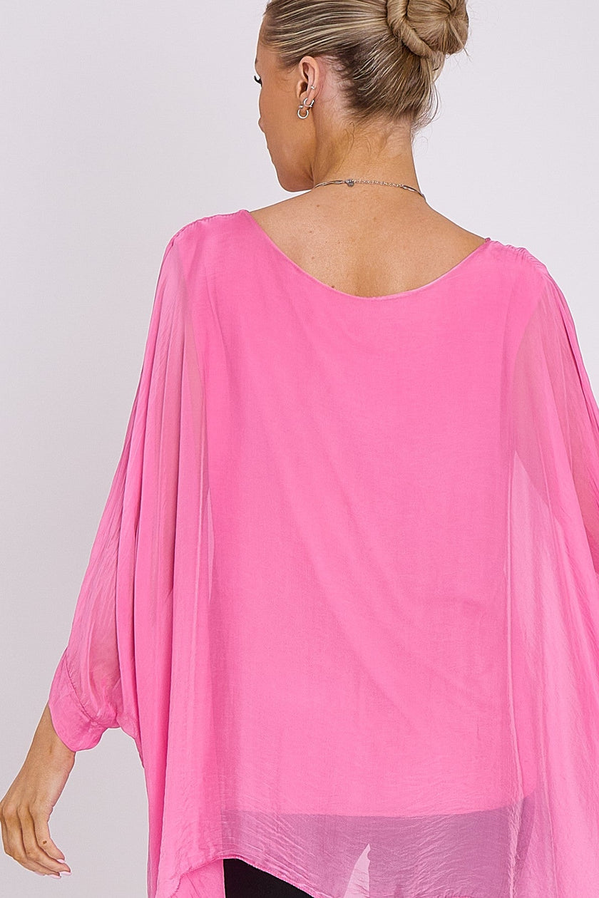 Blusa rosa in seta con maniche a pipistrello