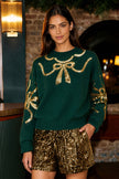 Jersey con escote de lazo y lentejuelas verdes de Yumi