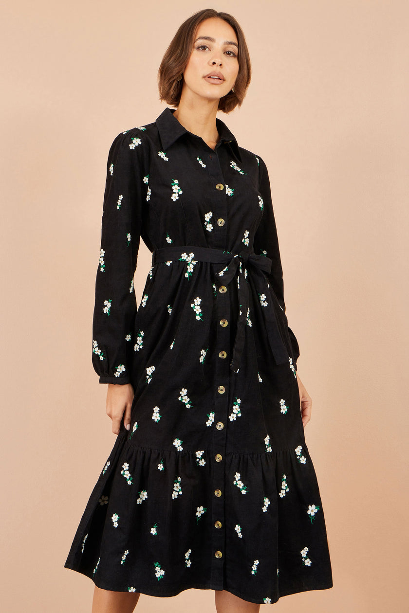 Yumi schwarzes Cordhemdkleid mit Gänseblümchen-Stickerei