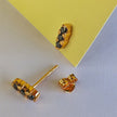 Boucles d'oreilles clous Trio en or avec zircones cubiques noires